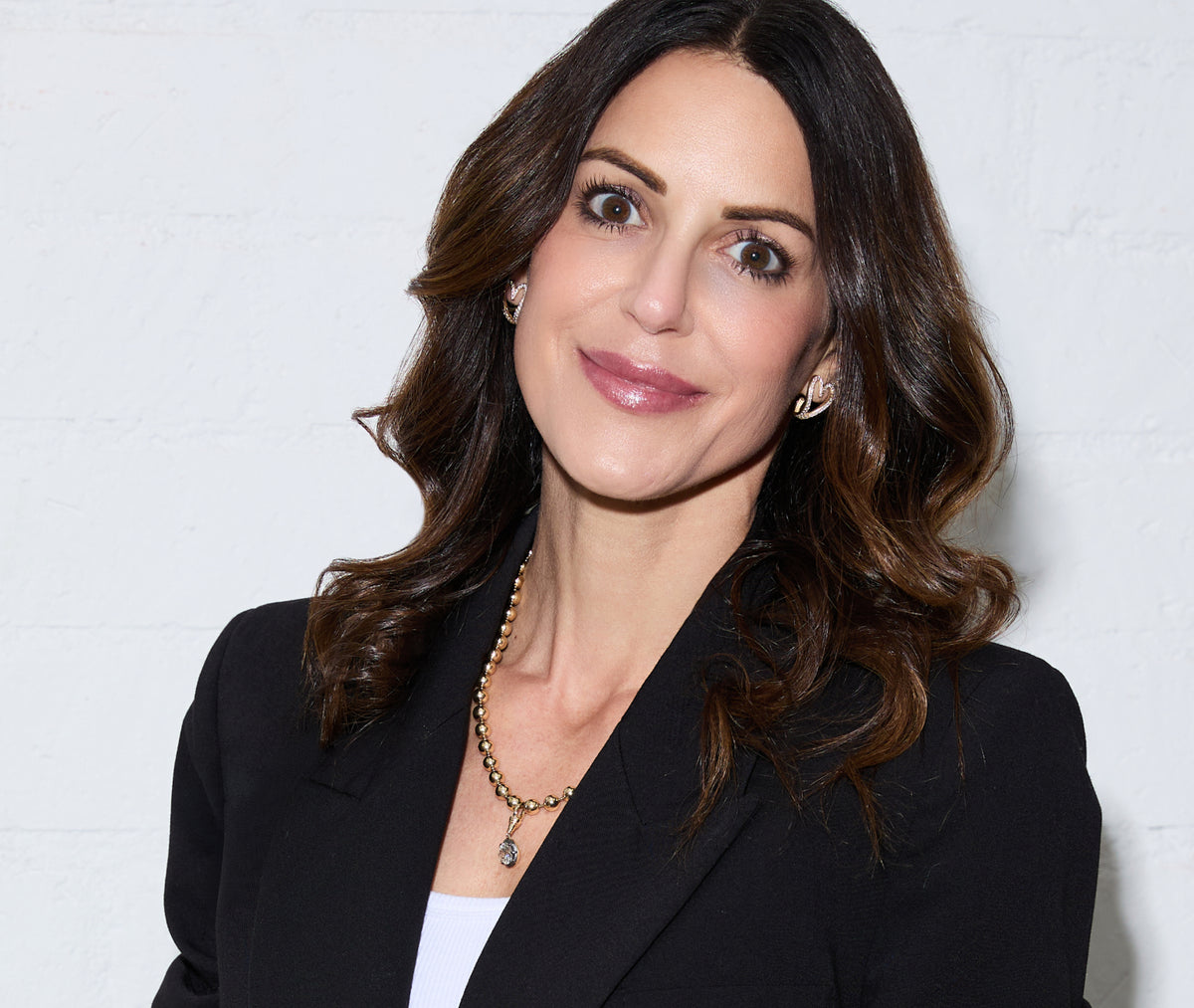 Woman wearing a black blazer against a white background