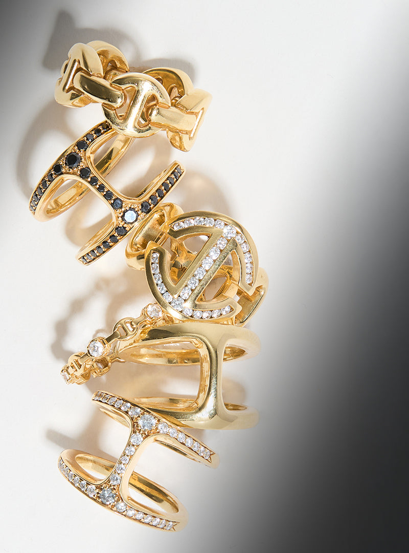 Gold rings with intricate designs on a gradient background