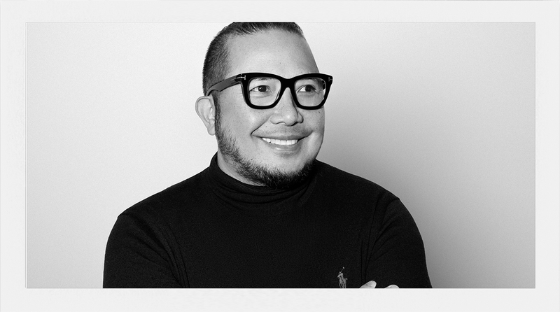 Black and white portrait of a person wearing glasses and a black turtleneck.