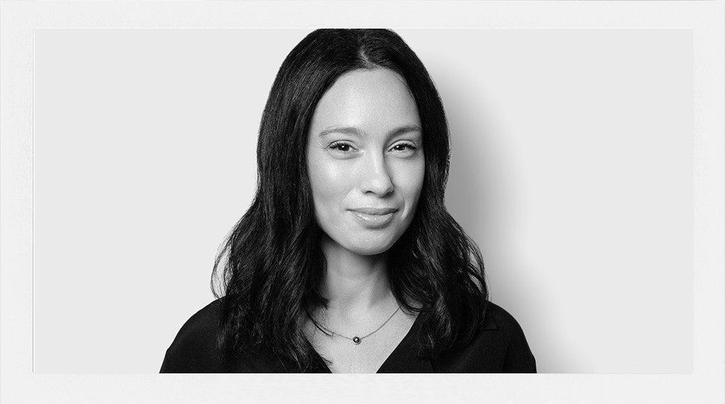 Black and white portrait of a woman with long hair on a plain background
