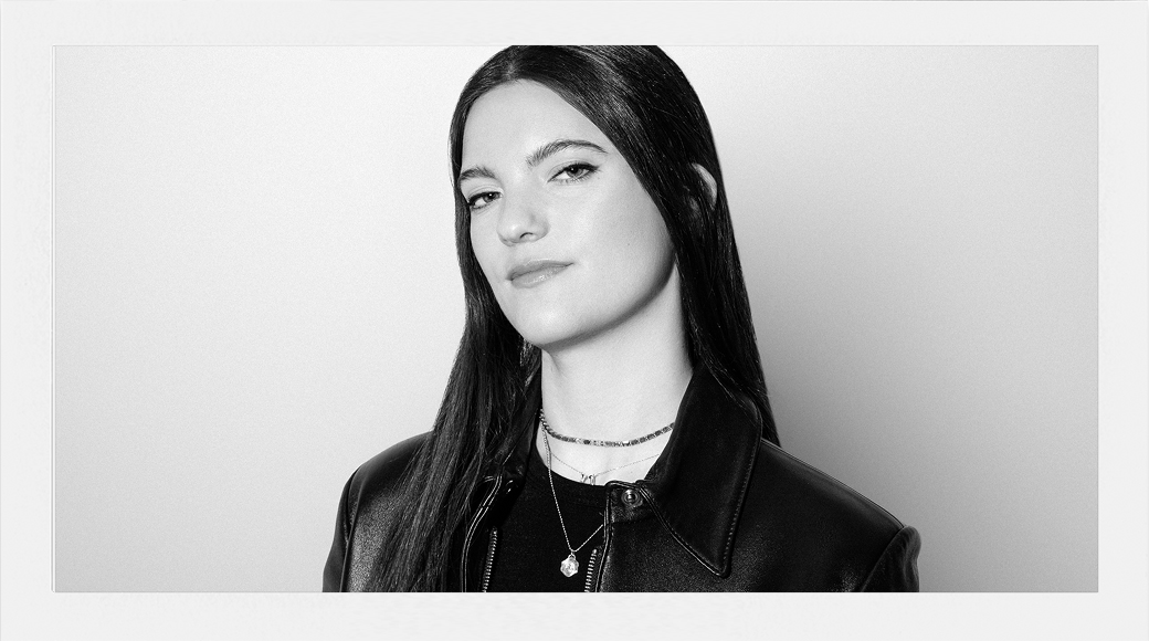 Black and white portrait of a woman with long hair on a plain background